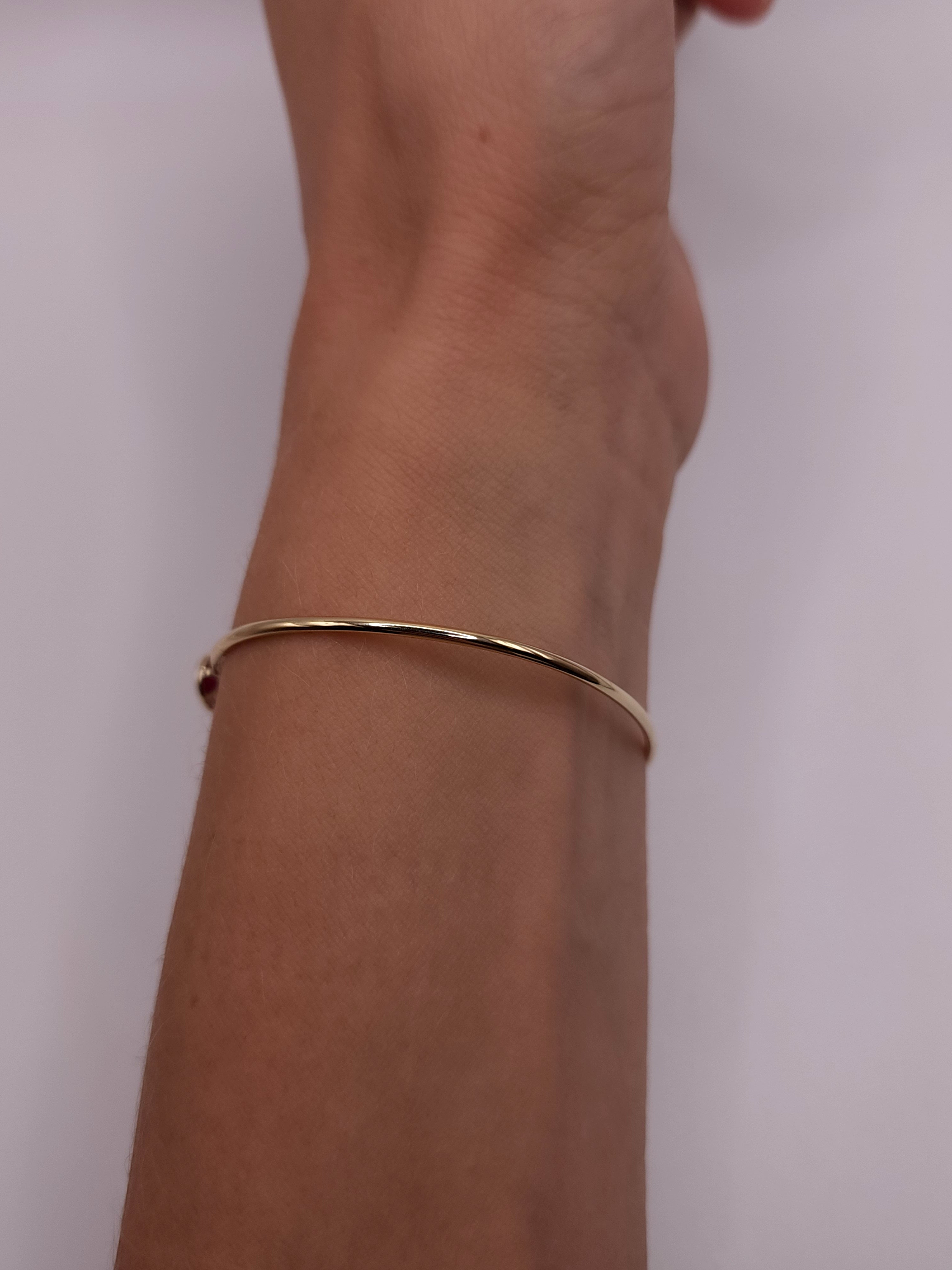 14Kt Gold Created Ruby Oval Bezel Bangle Bracelet
